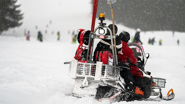 Ski Patrollers on BC Ski Hill practicing safe health & safety protocol.