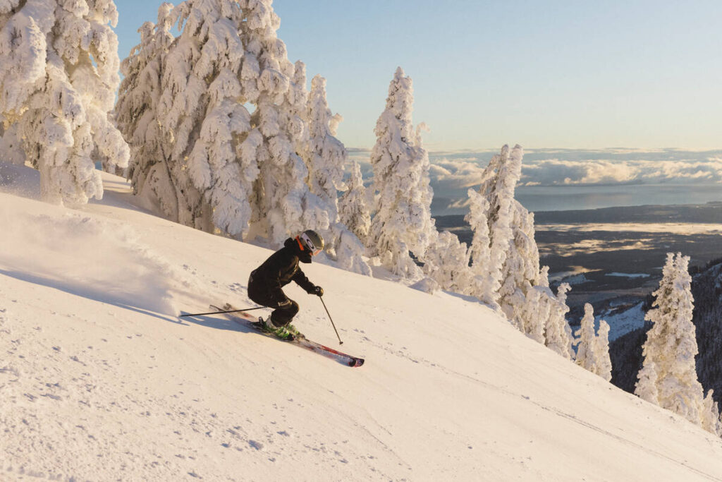 A woman skier on the frontside of Mount Washington Alpine Resort early in the morning.